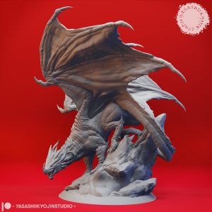 Ancient Red Dragon Miniature – Peak of Fire and Fury by Yasashii Kyojin Studio, shown mid-perch with wings unfurled and poised atop a craggy outcrop.