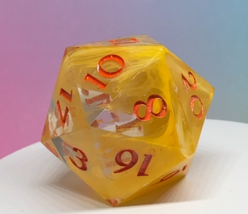 A handcrafted Chonky resin D20 named Sun-Kissed Slice of Chaos, featuring vibrant yellow resin with semi-clear sections and red inked numbers, glowing on a gradient backdrop.